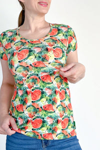 Woman wearing a colorful watermelon pattern t-shirt on a white background