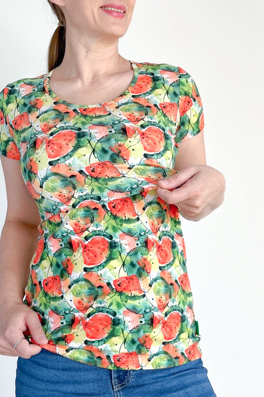 Woman wearing a colorful watermelon pattern t-shirt on a white background