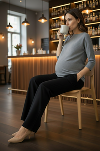 Woman sitting in a cozy cafe holding a cup.