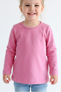 Child wearing a pink long-sleeve shirt and blue jeans on a white background